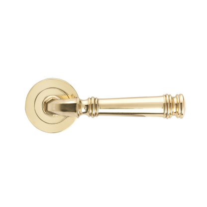 Product picture of the Tuscany Lever on Round Rose in Polished Brass on a white background.